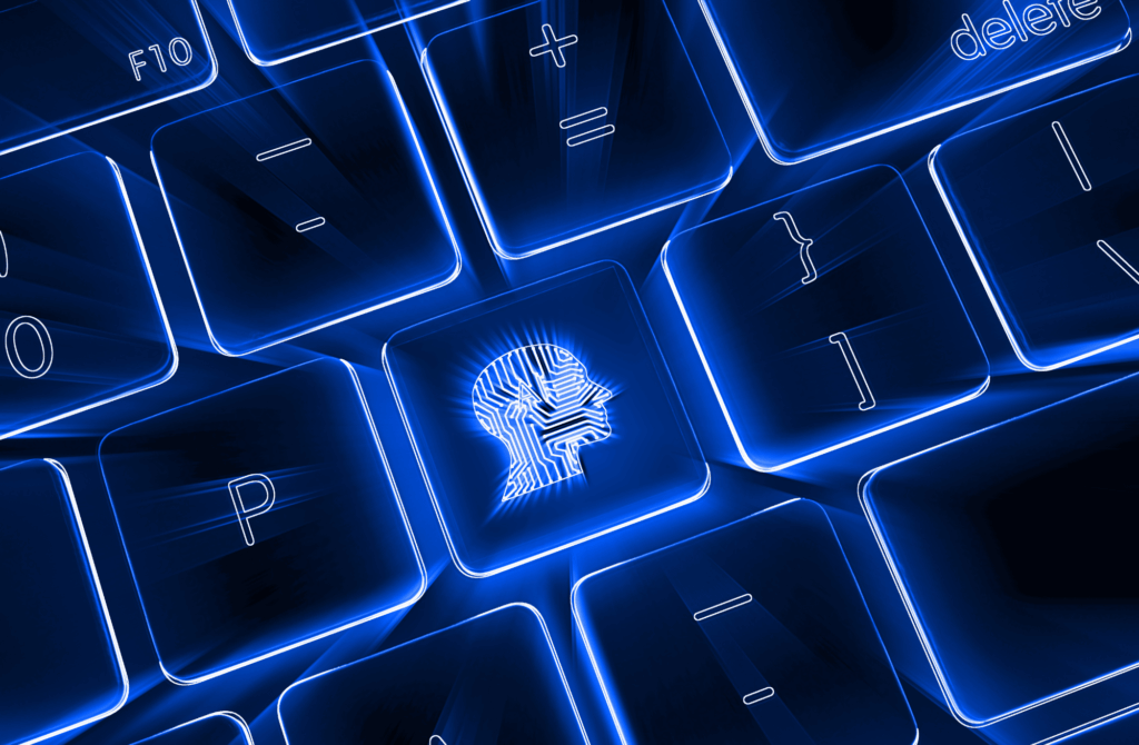 Podświetlona klawiatura komputera z wyróżnionym klawiszem przedstawiającym profil głowy ze wzorem obwodów – symbol sztucznej inteligencji i cyfrowego myślenia.